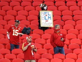 A Houston Texans fane holds a Black Lives Matter sign before the start of a game between the Kansas City Chiefs and the Houston Texans at Arrowhead Stadium on Thursday, Sept. 10, 2020, in Kansas City, Mo.