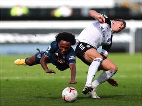 Willian of Arsenal is challenged by Tom Cairney of Fulham during the Premier League match between Fulham and Arsenal at Craven Cottage on Saturday, Sept. 12, 2020, in London, England.