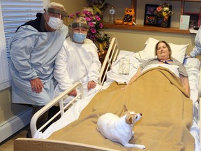 Hospice resident Diane Costello is visited by her parents Norman and Marolyn Hotchkiss, left, of Michigan and her pet dog Shamrock at The Hospice Village on Friday, Sept. 18, 2020.