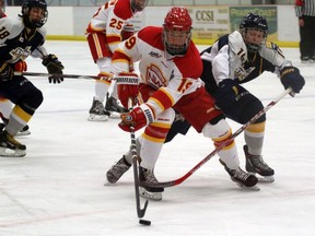 Dylan Holloway, left, of the Calgary Flames battles through a hook by Bailey Tokarz of the Ernie's Sports Experts Storm in Alberta Midget AAA Hockey League action on Oct. 8, 2016, in Grande Prairie, Alta. Holloway is ranked 12th among North American skaters by the NHL Central Scouting for 2020 NHL Entry Draft: Credit: Logan Clow/Grande Prairie Daily Herald-Tribune/Postmedia Network ORG XMIT: POS1610081632550798