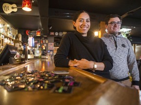 Natalya Mason, right, education coordinator for Saskatoon Sexual Health, and Damian Andersen-Crouch, volunteer with Saskatoon Sexual Health, with some samples of condoms and drink coasters distributed to local bars during the organization's Condom Blitz at the Capitol bar in Saskatoon on Nov. 28, 2019.