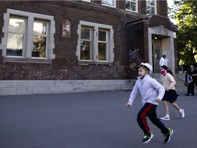 A group of children laugh and scream as they hold impromptu races in the school yard at Bancroft Elementary School in Montreal, on Monday, August 31, 2020. (Allen McInnis / MONTREAL GAZETTE)