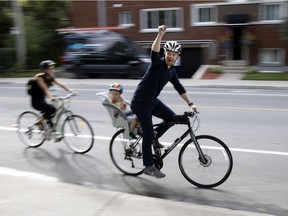 A cyclists yells his support to a small group gathered to support the Terrebonne Street bike path in Montreal, on Friday, September 4, 2020. (Allen McInnis / MONTREAL GAZETTE)