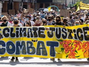 People march in Montreal to protest the lack of action on climate change, Sept. 26, 2020.