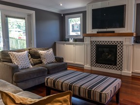 This living room was redesigned to provide hidden storage for children's toys and an office workstation for the parents.