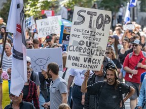Demonstrators protest peacefully against the Quebec government's mandatory mask law in Montreal on Saturday September 12, 2020. The crowd was made up of anti-mask supporters, anti-vaxxers, Quebec independence, Trump and QAnon supporters.