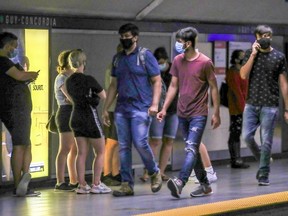 Mask-wearing transit users on the platform at the Guy-Concordia métro station in Montreal Monday August 24, 2020.