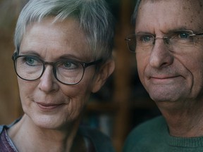 Confident senior couple looking out of window