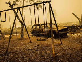 A charred swing set and car are seen after the passage of the Santiam Fire in Gates, Ore., Sept. 10. Pandemic-laced 2020 has felt like a natural disaster, Saleema Nawaz writes.