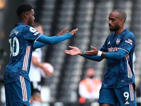 Arsenal's French striker Alexandre Lacazette (R) is substituted for Arsenal's English striker Eddie Nketiah (L) during the English Premier League football match between Fulham and Arsenal at Craven Cottage in London September 12, 2020.