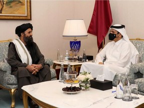 Qatar's Deputy Prime Minister and Foreign Minister Sheikh Mohammed bin Abdulrahman al-Thani(R) meet with Taliban co-founder Mullah Abdul Ghani Baradar on the sidelines of the opening ceremony of the Afghan negotiations Sept. 12, 2020.