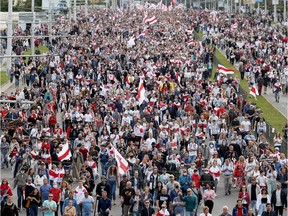 Opposition supporters parade through the streets during a rally to protest against the presidential election results in Minsk on Sunday, Sept. 13, 2020.  Belarusians have been demonstrating against the disputed re-election of President Alexander Lukashenko for a month, with more than 100,000 people flooding the streets of Minsk for four straight weekends.