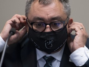 Horacio Arruda says he finds wearing a mask during a long day difficult and is happy to remove it when sitting alone in his office.