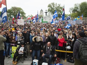 Demonstrators at the National Assembly in Quebec City protest against measures to stop the transmission of COVID-19 on Tuesday.