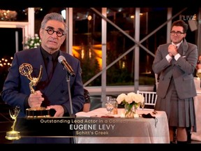 This handout picture released courtesy of Image Group LA / American Broadcasting Companies, Inc. / ABC shows host Canadian actor Eugene Levy speaks after receiving his Emmy while his son actor/director/writer Daniel Levy watches during the 72nd Primetime Emmy Awards ceremony held virtually on Sunday, Sept. 20, 2020.