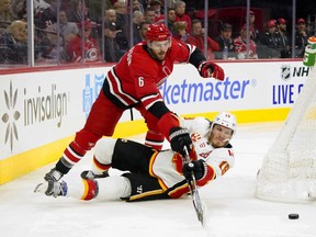 Carolina Hurricanes defenceman Joel Edmundson knocks Calgary Flames left-wing Matthew Tkachuk to the ice during the third period at PNC Arena on Oct. 29, 2019.