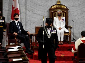 Governor General Julie Payette looks on with Chief of Defence Staff Jonathan Vance (L) and Prime Minister Justin Trudeau as the Usher of the Black Rod Greg Peters leaves to summon the House of Commons to come listen to the throne speech in the Senate chamber in Ottawa.