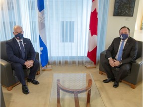 Federal Conservative Leader Erin O'Toole, left, and Quebec Premier François Legault get set to start their meeting in Montreal on Sept. 14, 2020.