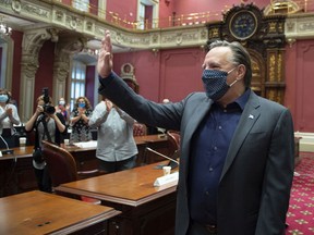 Premier François Legault waves to members of his caucus at a CAQ government pre-session caucus, on Sept. 11, 2020, at the Legislature in Quebec City.