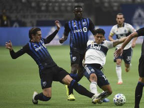 Montreal Impact defender Luis Binks (5) plays for the ball against Vancouver Whitecaps forward Fredy Montero (12) during the first half at BC Place on Wednesday, Sept. 16, 2020, in Vancouver.