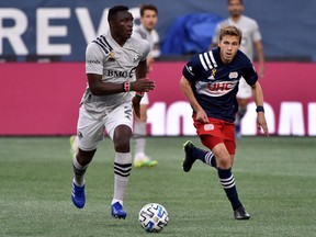 Montreal Impact midfielder Victor Wanyama controls the ball as New England Revolution midfielder Scott Caldwell pursues during the first half at Gillette Stadium in Foxborough, Mass., on Sept 23, 2020.