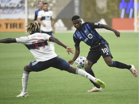 Whitecaps midfielder Leonard Owusu defends against Impact midfielder Orji Okwonkwo during the second half at B.C. Place on Sunday.