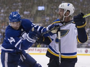 Toronto Maple Leafs center Auston Matthews (34) gets tied up with St. Louis Blues defenceman Joel Edmundson (6), as the Toronto Maple Leafs lose in overtime 2-1 to the St. Louis Blues at the Air Canada Centre,  on Jan. 16, 2018.