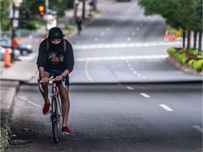 A masked cyclist makes his way north up Atwater Avenue in Montreal on Monday September 7, 2020. Dave Sidaway / Montreal Gazette ORG XMIT: 64974