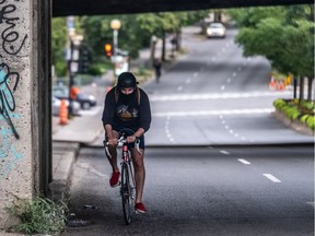 A masked cyclist makes his way north up Atwater Ave. in Montreal on Monday September 7, 2020.