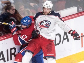 Columbus Blue Jackets forward Josh Anderson checks Canadiens defenceman Brett Kulak into the boards during NHL game at the Bell Centre in Montreal on Feb. 19, 2019.