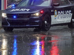 MONTREAL, QUE.: SEPTEMBER 29, 2020 -- A Montreal Police car speeds through the rain along Boul. René-Lévesque in Montreal Tuesday September 29, 2020. (John Mahoney / MONTREAL GAZETTE) ORG XMIT: 65081 - 5588