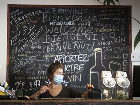A waitress at local Chinese restaurant tallies up her receipts on Wednesday September 30, 2020 during the COVID-19 pandemic. Restaurants will only do delivery or takeout during the government imposed red alert, imposed to curb the surging number of new cases in Montreal.