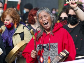 An Indigenous woman leads chants during "Justice for Joyce" Echaquan demonstration in Montreal Oct. 4, 2020.