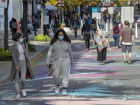 MONTREAL, QUE.: OCTOBER 4, 2020 -- Pedestrians walk on Ste-Catherine St. in Montreal Sunday October 4, 2020. (John Mahoney / MONTREAL GAZETTE) ORG XMIT: 65105 - 3322