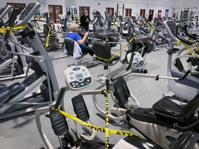 Early-morning exercisers get in a workout at a Montreal gym Oct. 5, days before the city's gyms had to close again.