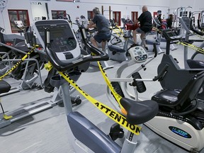 People take part in an early morning workout at a Montreal gym on Monday October 5, 2020. The Quebec government has decided that all gyms in the province red zones will close on Thursday because of the COVID-19 pandemic.