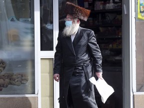 A Hasidic Jewish man leaves a grocery store on Bernard Ave. in the Outremont borough of Montreal Wednesday October 7, 2020.