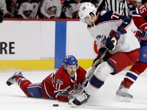 Canadiens winger Brendan Gallagher hits the ice while Blue Jackets' Josh Anderson takes control of the puck during a game at the Bell Centre in 2017.