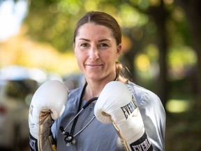 Kim Clavel, a boxer and nurse, has been named to Time Magazine's Next Generation Leaders edition, a biannual selection of rising stars in politics, technology, culture, science, sports and business. Clavel with gloves and scrubs outside her home in Montreal on Sunday Oct. 11, 2020.