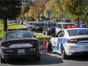 Police monitor foot traffic on Mount Royal to ensure people keep a distance from each other on April 4, 2020.