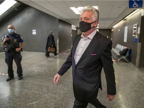 Just for Laughs founder Gilbert Rozon walks through the hall at the Palais de Justice in Montreal on Oct. 13, 2020, before his trial on rape charges.