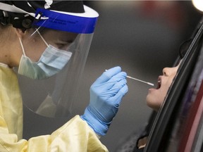 Audrée Robert administers a COVID-19 test at the Olympic stadium.