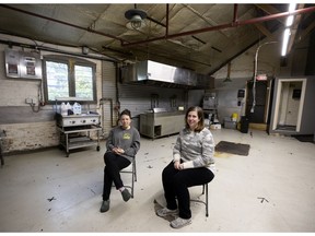 Owners Gaëlle Cerf, left, and Hilary McGown sit in what was once the bustling kitchen area of their Grumman '78 restaurant. “I feel like I’ve lost my home and I’ve lost my people,” McGown says.
