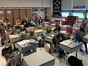 Grade 6 students don their masks in class at Clearpoint School in Pointe-Claire.
