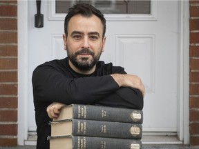 Montreal poet Carmine Starnino at home with some of the tomes of the 1962 Oxford English Dictionary on Friday Oct. 23, 2020. Starnino recently learned that he is cited twice in the Oxford English Dictionary, for his use of the words "leaf-light" and "lenten-faced".