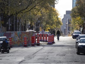 A cyclist has part of Ste-Catherine St. in the Village to himself in October 2020.