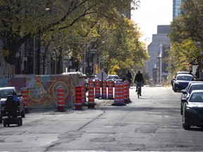 A cyclist has several blocks of Sainte Catherine Street to himself in the middle of a Saturday afternoon in the Gay Village district of Montreal, on Oct. 24, 2020.