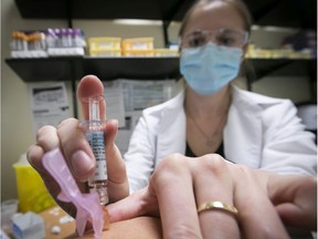 Nurse Jessica Mann Bourgouin administers flu shot on Thursday, Oct. 29, 2020.