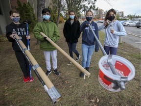 Grade 7 students Thomas Gammon, left, Tarun Philip, Sofia Simetic, Olivia Potvin and Emma Hlopasko outside Centennial Regional High School in Greenfield Park, south of Montreal Thursday October 29, 2020.  The students took part in a challenge for secondary 1 students to design a device that will safely deliver candy for Halloween during a pandemic.  (John Mahoney / MONTREAL GAZETTE) ORG XMIT: 65225 - 3770