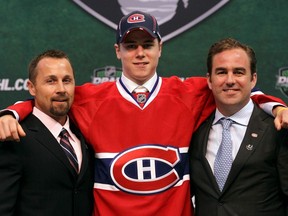 Nathan Beaulieu, the 17th overall pick by the Montreal Canadiens, is flanked by Trevor Timmins, left, and team owner Geoff Molson at the 2011 NHL entry draft on June 24, 2011, in St. Paul, Minn.